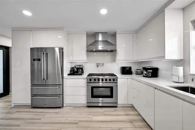 a kitchen with a stove top oven and refrigerator