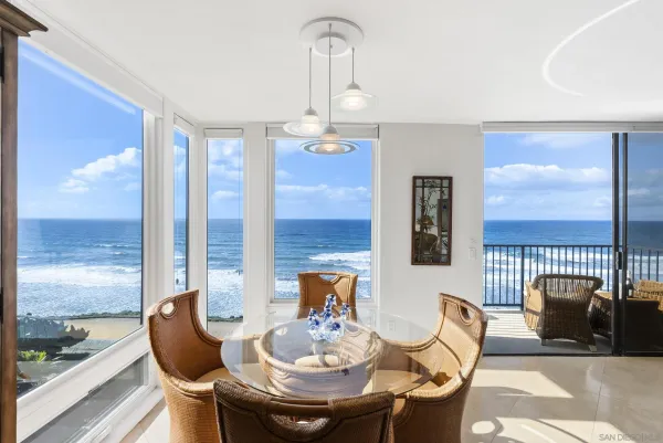 a dining room with furniture a chandelier and wooden floor