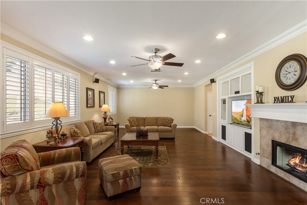 33351 Nicholas Common Temecula, CA 92592 - Photo 13 of 42 a living room with furniture a fireplace and a large window