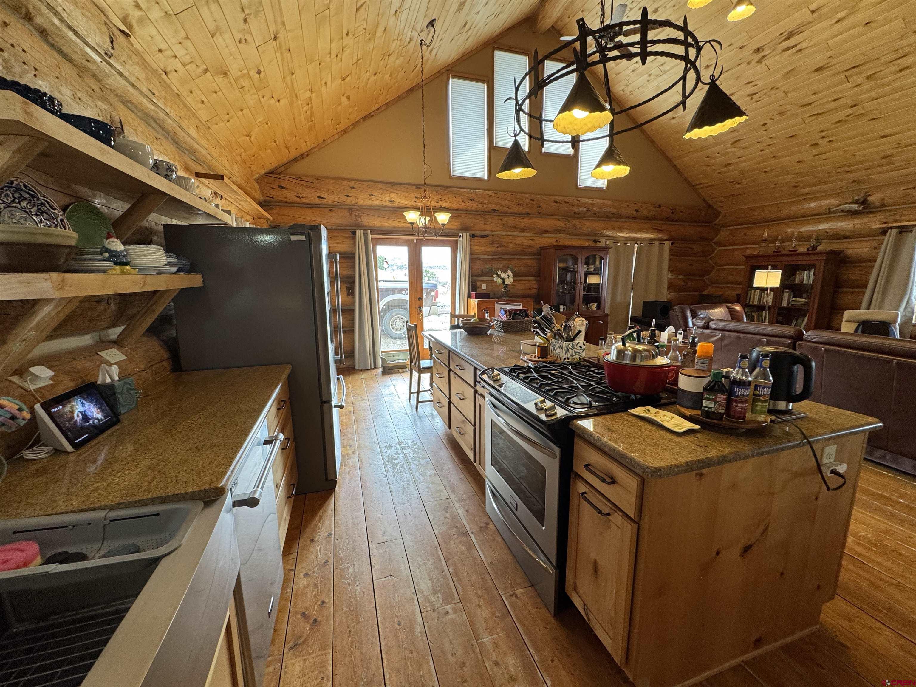366 Frisco Pass Del Norte, CO 81132 - Photo 12 of 34 a kitchen with stainless steel appliances granite countertop a stove and a wooden floors