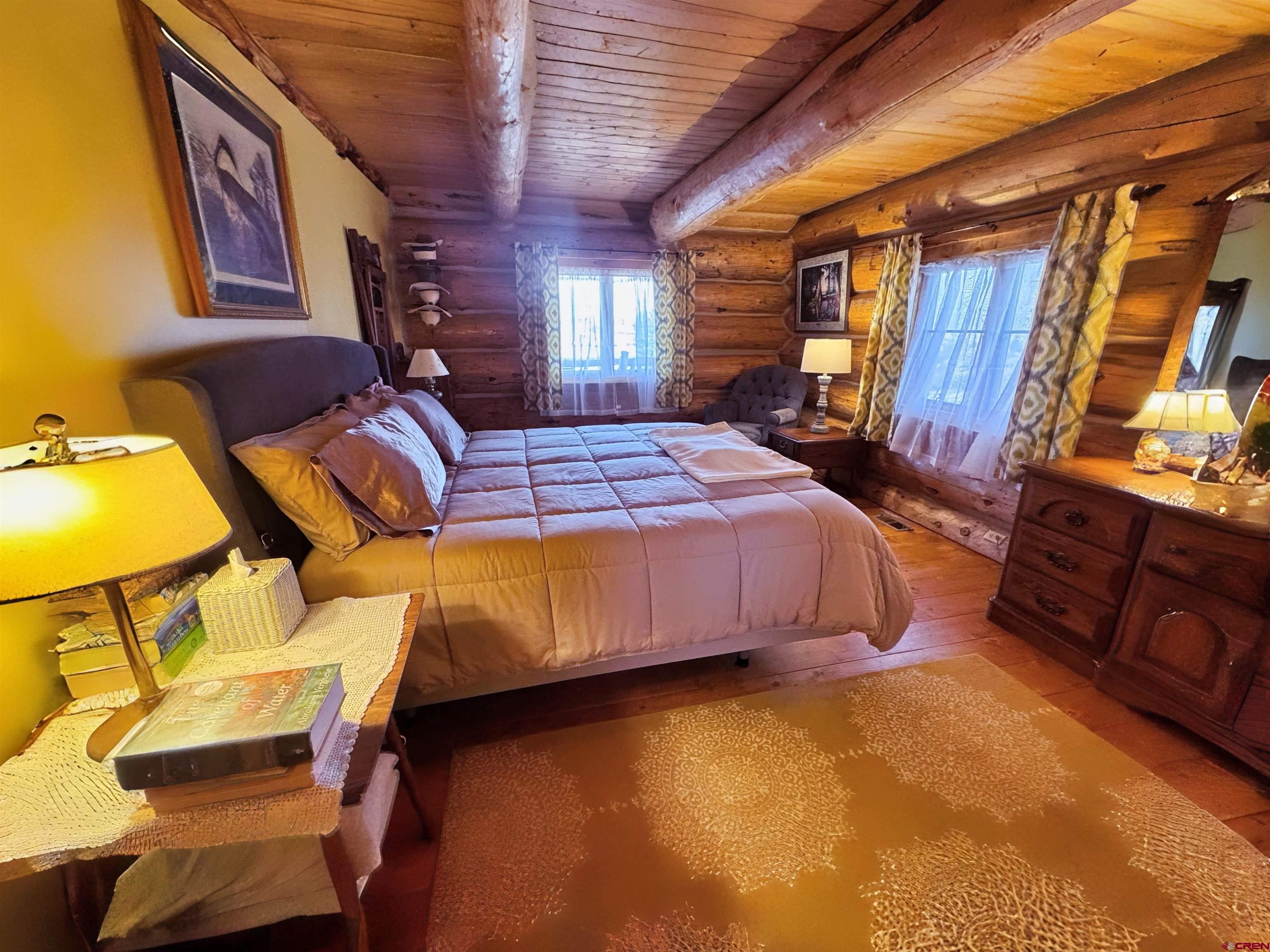 366 Frisco Pass Del Norte, CO 81132 - Photo 16 of 34 a bedroom with a bed and wooden floor