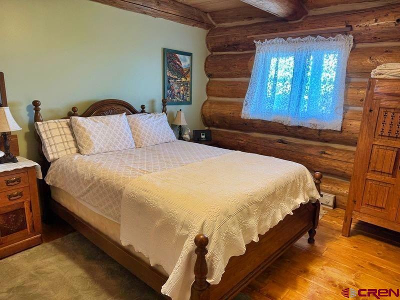 366 Frisco Pass Del Norte, CO 81132 - Photo 20 of 34 a bed sitting in a bedroom next to a window