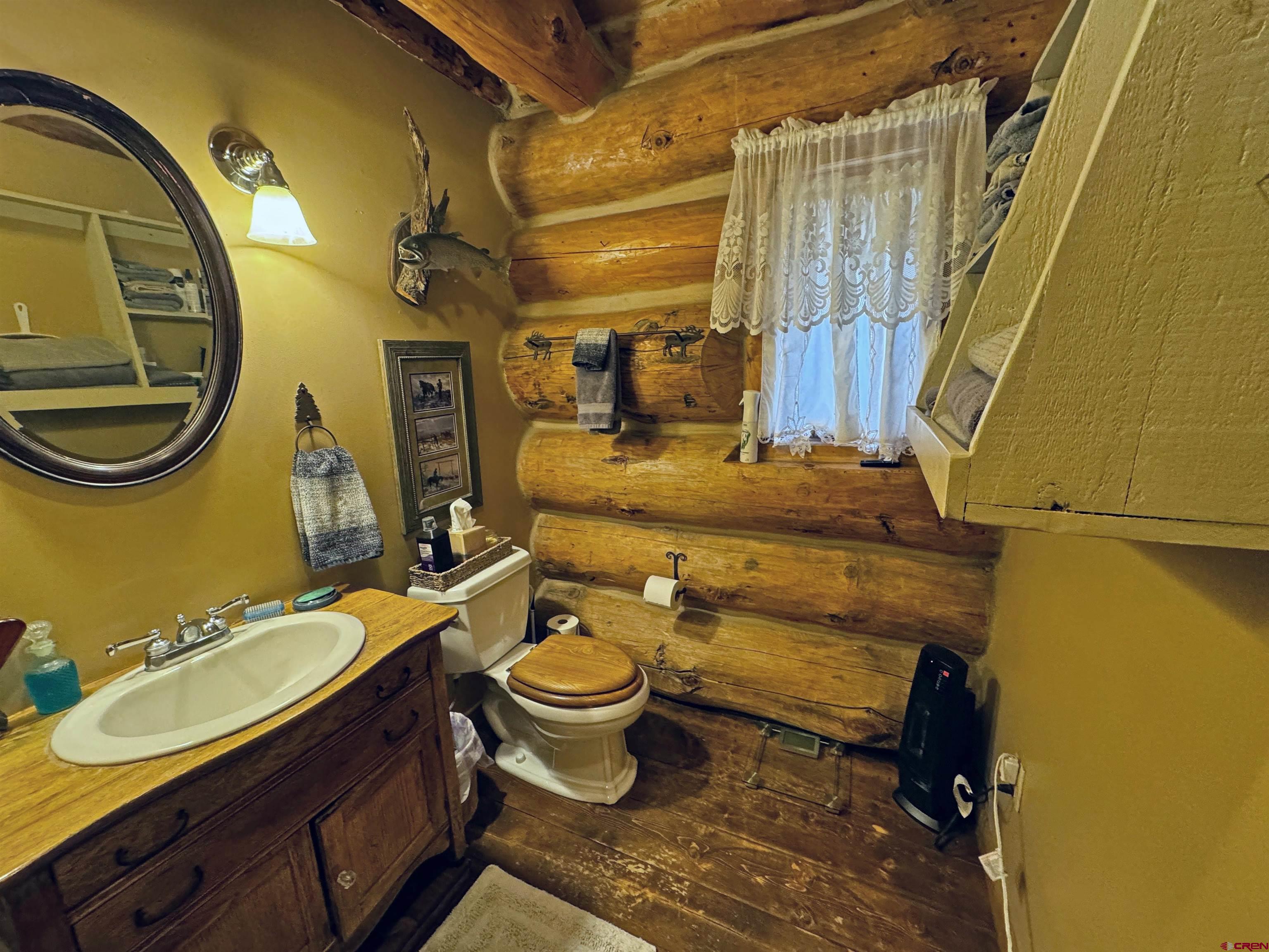366 Frisco Pass Del Norte, CO 81132 - Photo 21 of 34 a bathroom with a granite countertop toilet sink and mirror