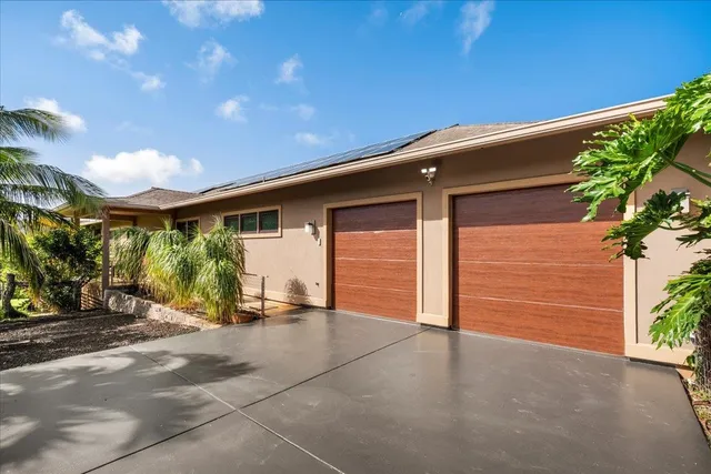 a living room with furniture a ceiling fan and a large window
