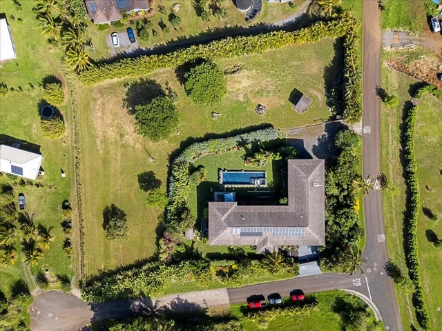 a living room with furniture kitchen view and a wooden floor