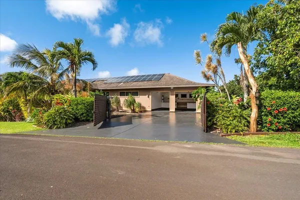 a front view of a house with a yard and a garage