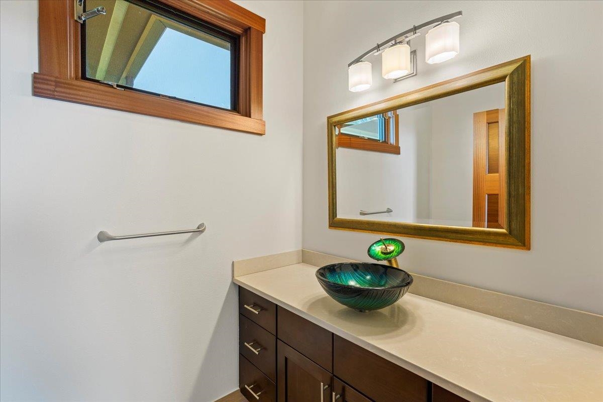 10 Leleaka Place Haiku, HI 96708 - Photo 25 of 49 a bathroom with a sink a mirror and a window