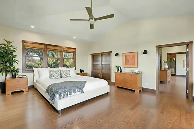 a bedroom with a large bed and a window