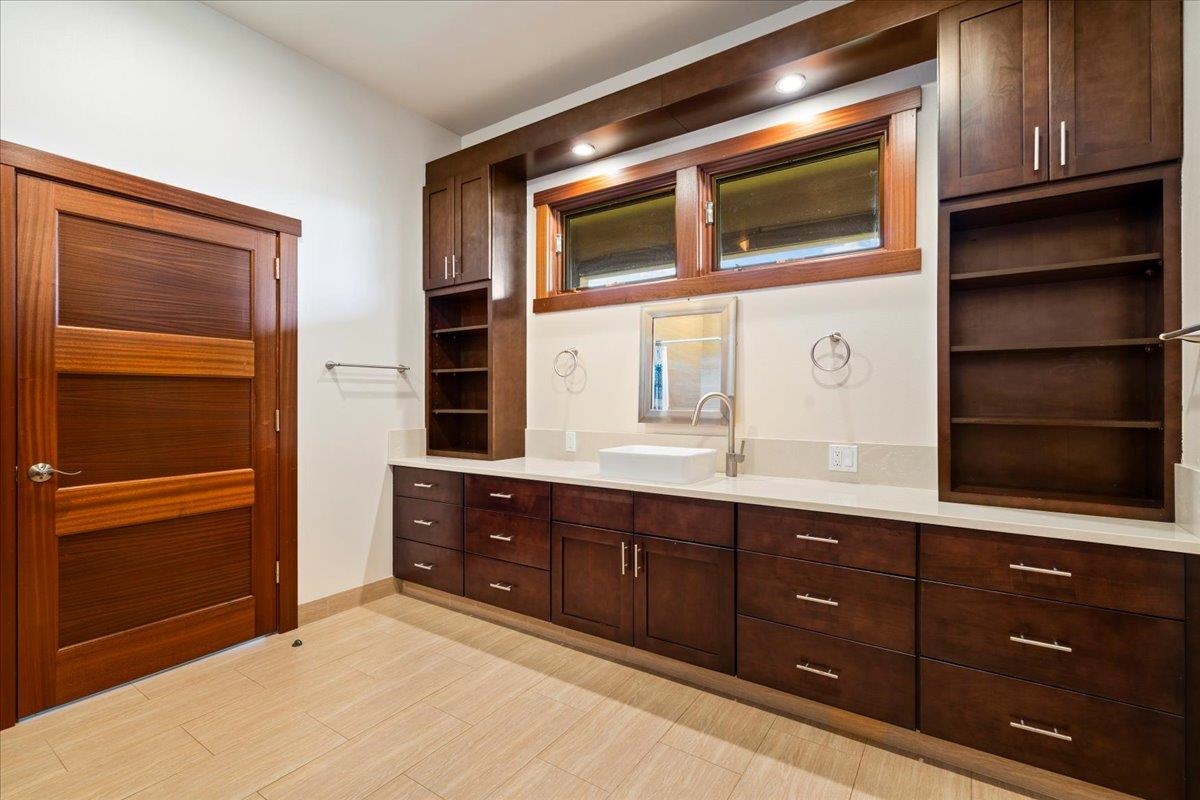 10 Leleaka Place Haiku, HI 96708 - Photo 33 of 49 a kitchen with a wooden cabinets and a stove top oven