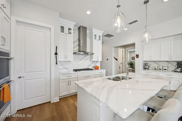 a large kitchen with a table and chairs