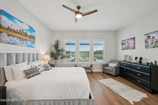 a bedroom with a bed and a large window