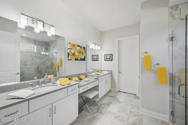 a bathroom with a sink mirror and vanity