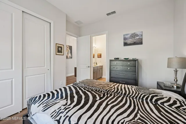 a en suite bathroom with a double vanity sink a mirror and a bathtub
