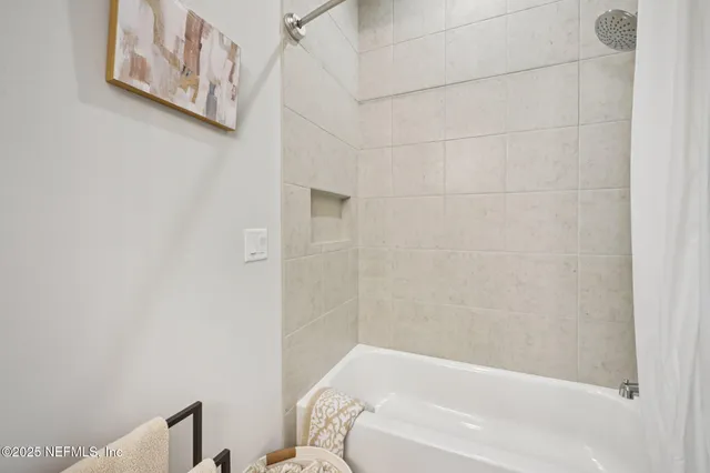 a bedroom with a bed and a night stand