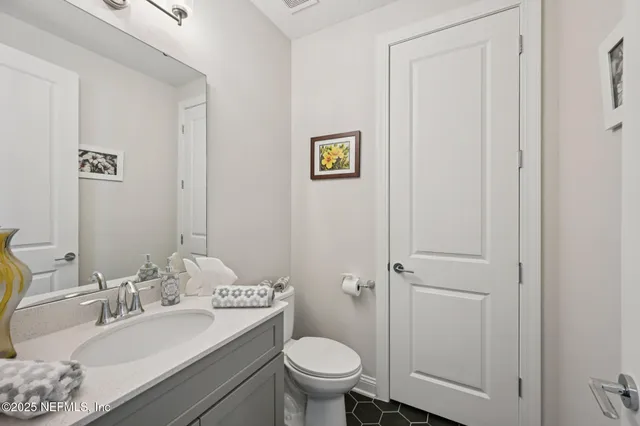 a living room with furniture a flat screen tv and a window