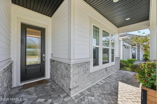 a room with wooden floor and a chandelier