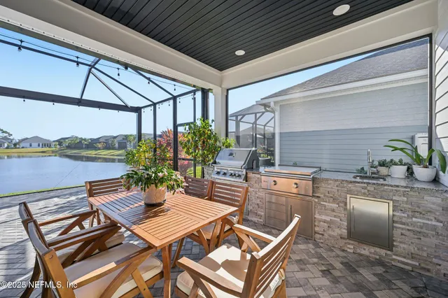 a view of a house with brick walls and a yard with plants