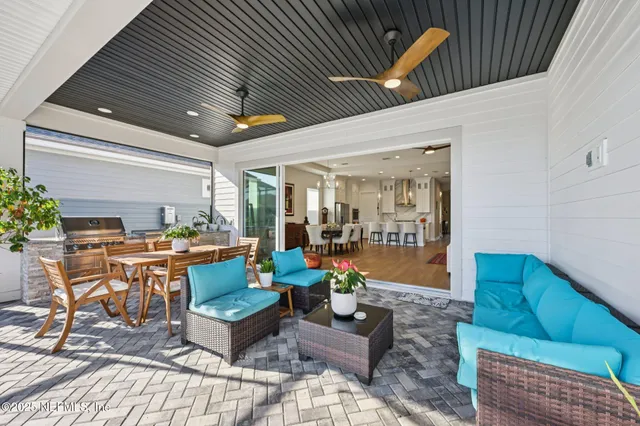 a front view of a house with a yard and potted plants