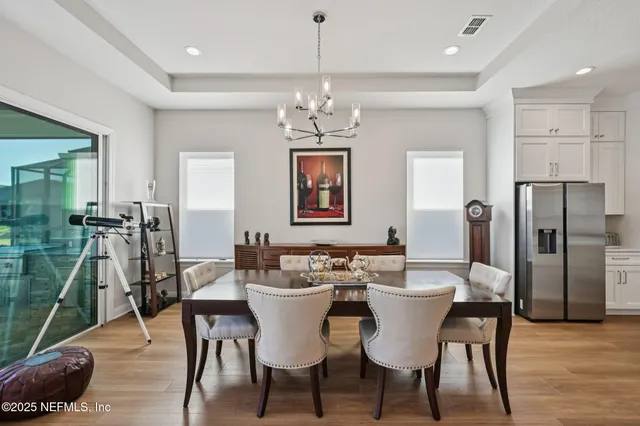 a kitchen with stainless steel appliances kitchen island granite countertop a kitchen island and chairs in it