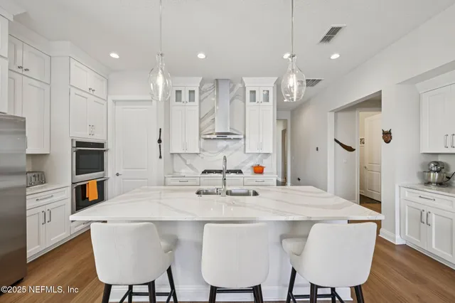 a kitchen with stainless steel appliances granite countertop a stove and a microwave