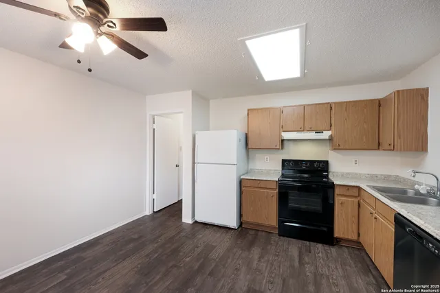 a kitchen with a stove a sink and a refrigerator
