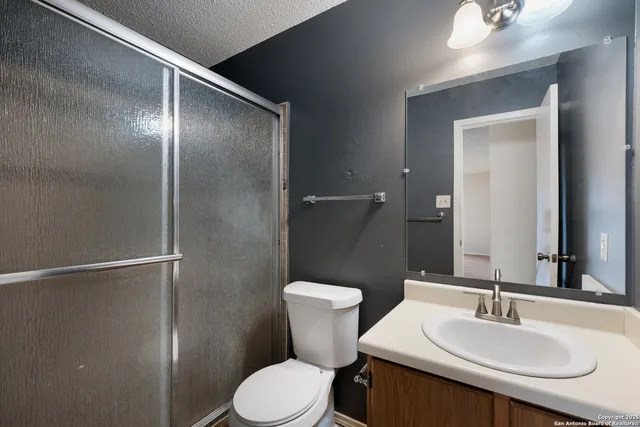 a bathroom with a sink toilet and mirror