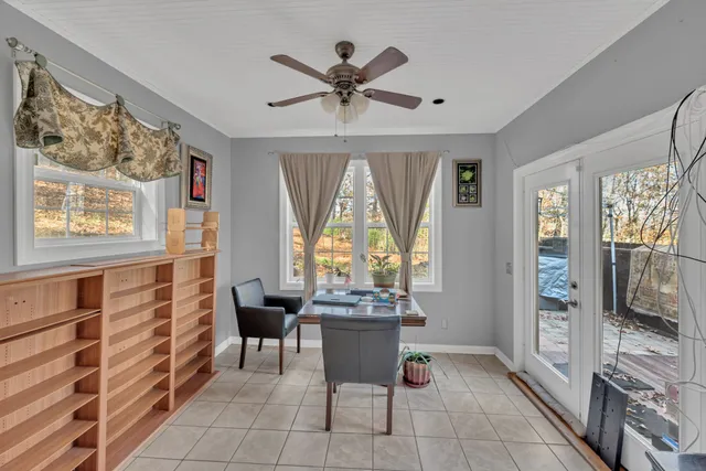 a dining room with furniture and windows