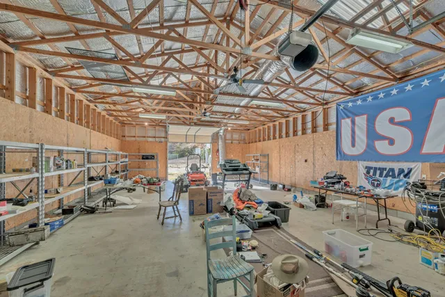 a living room with lots of furniture and clothes
