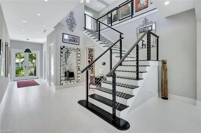 a living room with lots of furniture and a painting on the wall