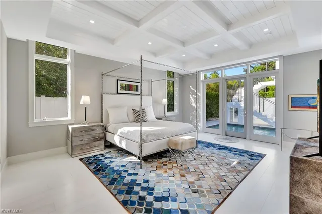 a bedroom with furniture and a rug