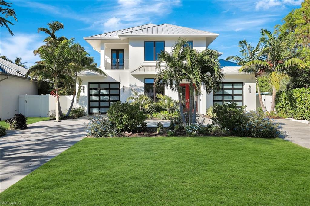 739 5th Avenue North Naples, FL 34102 - Photo 5 of 35 a front view of a house with a yard