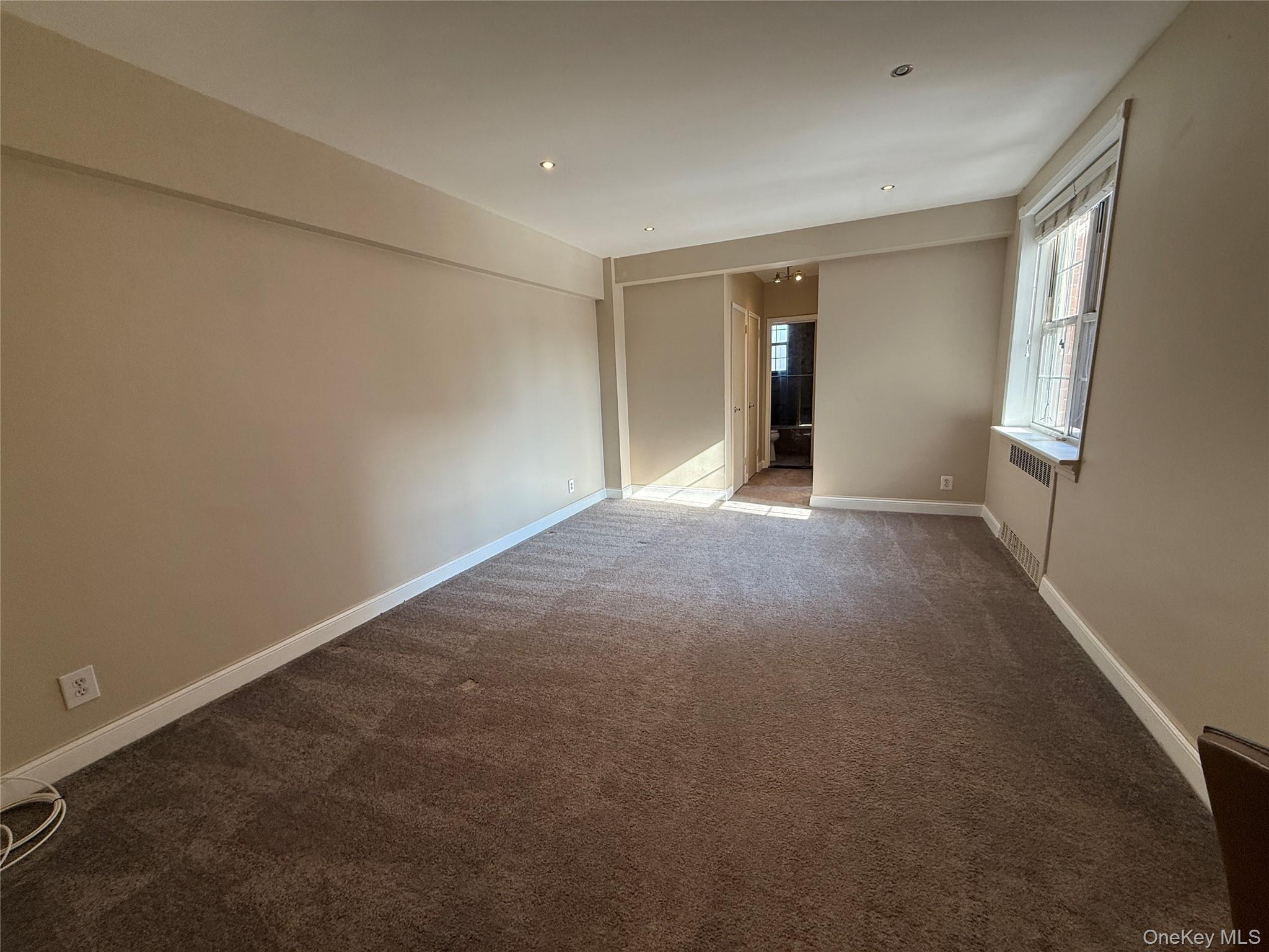 796 Bronx River Road, Unit B38 Bronxville, NY 10708 - Photo 4 of 31 a view of an empty room with wooden floor and windows