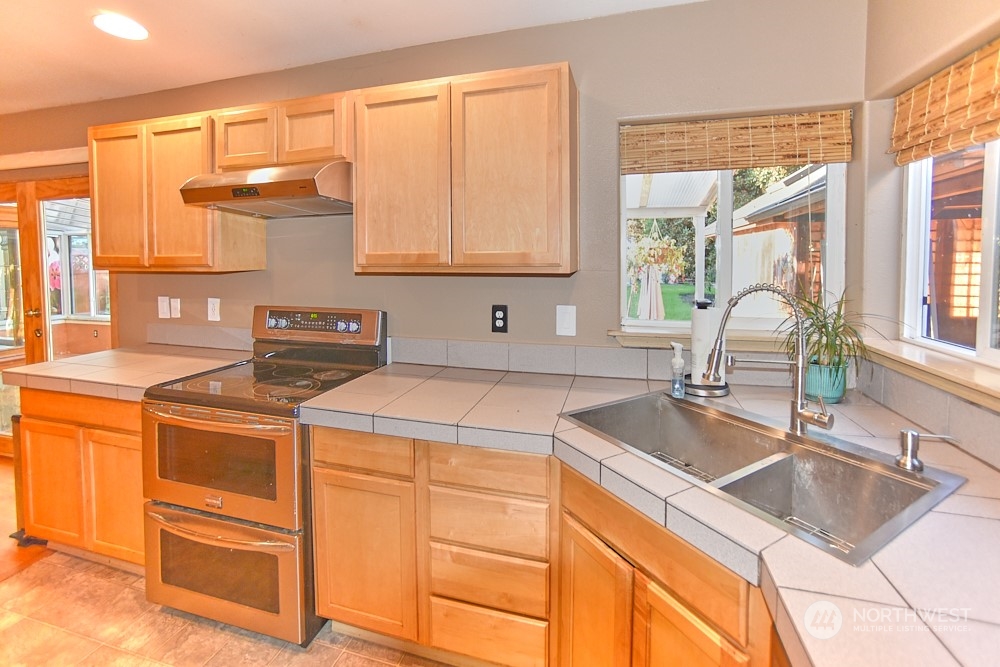 133 120th Street Southeast, Unit B Everett, WA 98208 - Photo 5 of 14 a kitchen with a sink stove and cabinets