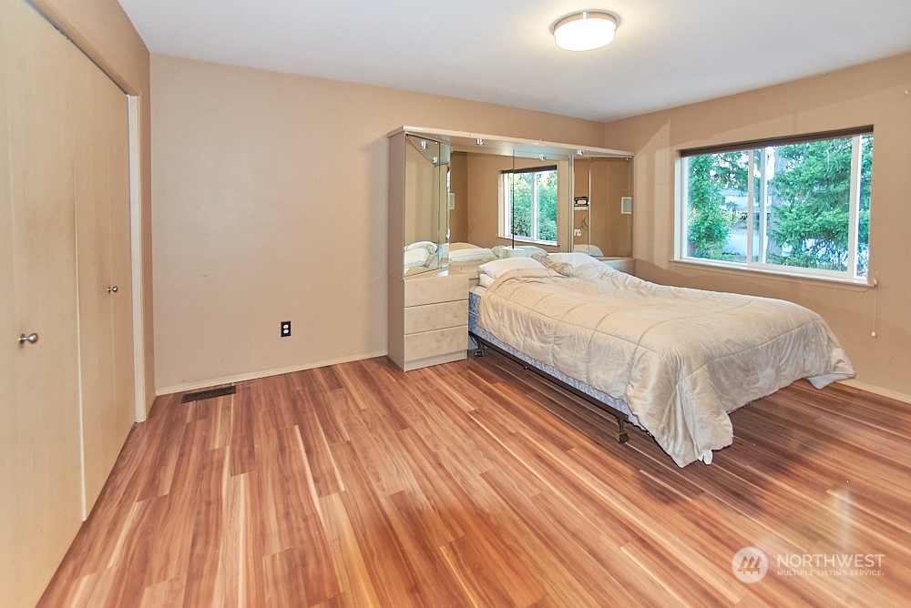 133 120th Street Southeast, Unit B Everett, WA 98208 - Photo 7 of 14 a large bed sitting in a bedroom next to a window