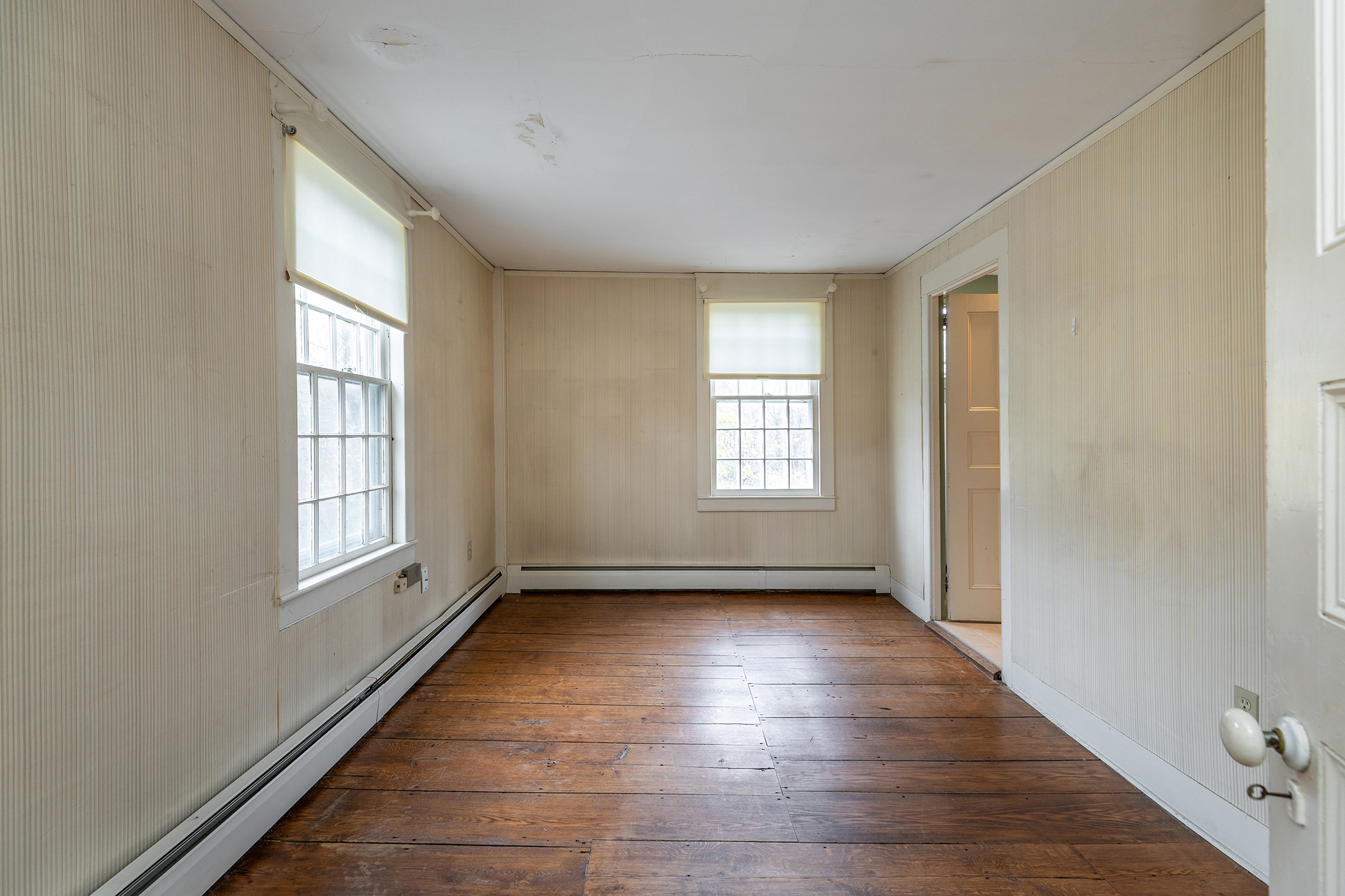 28 Sunny Ridge Road Washington, CT 06793 - Photo 18 of 35 a view of an empty room with a window and wooden floor