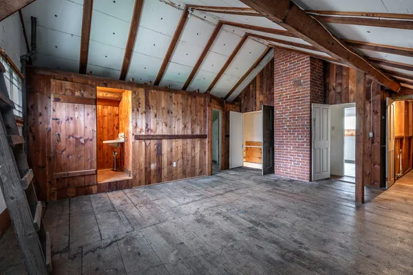 a view of a kitchen with wooden floor and a sink
