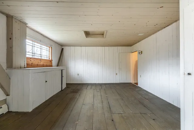 a view of a kitchen with wooden floor and a sink