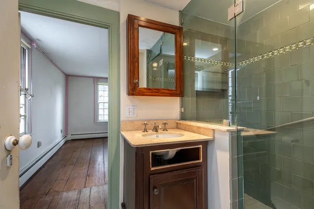 a bathroom with a shower and a mirror
