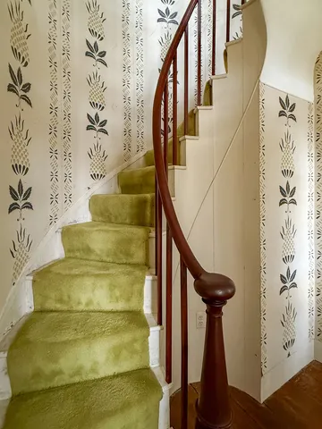 a view of an entryway with wooden floor and stairs