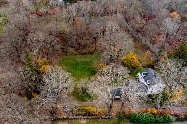 an aerial view of a house with a yard