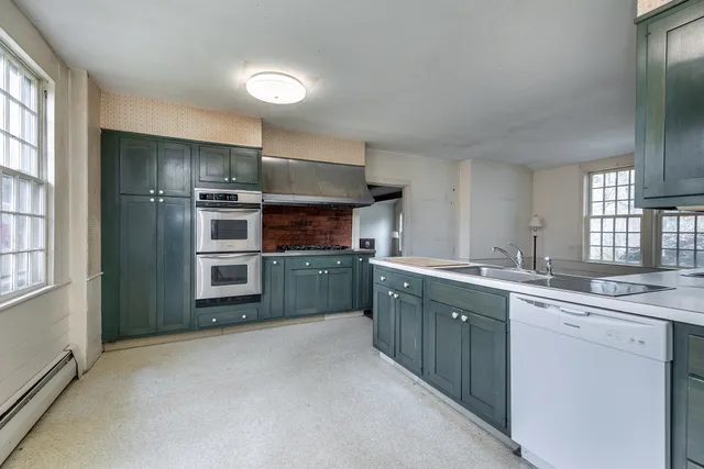a kitchen with a sink cabinets and stainless steel appliances
