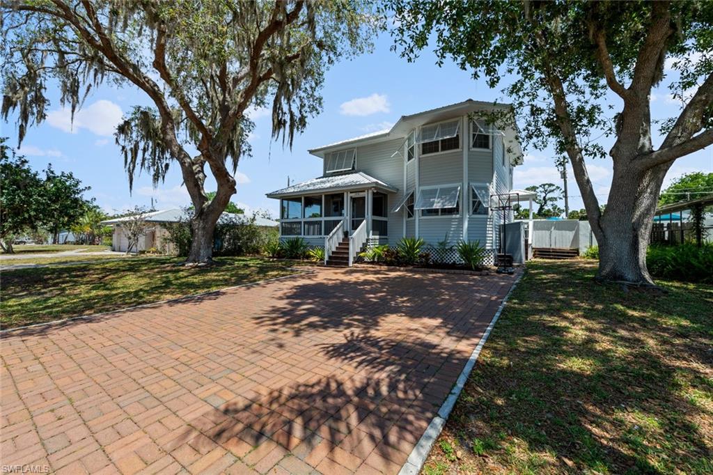 a pathway of a house with a yard