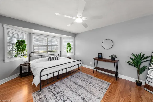 a spacious bedroom with a bed a chandelier and a window