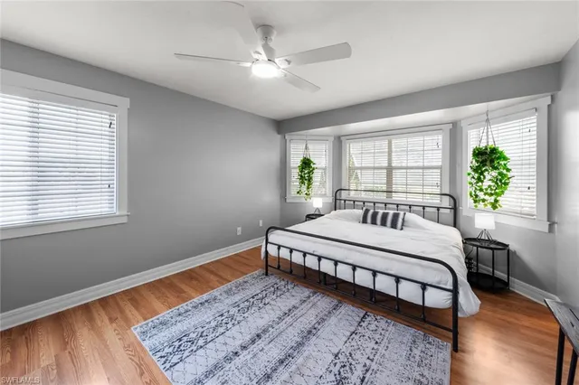 a bed sitting in a bedroom next to a window