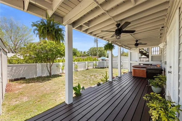 a outdoor space with wooden floor and a ceiling fan