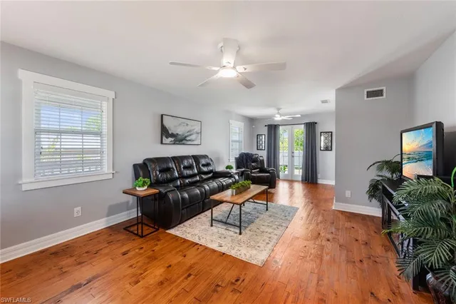 a living room with furniture and wooden floor