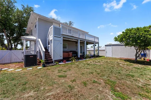 a view of a house with wooden fence