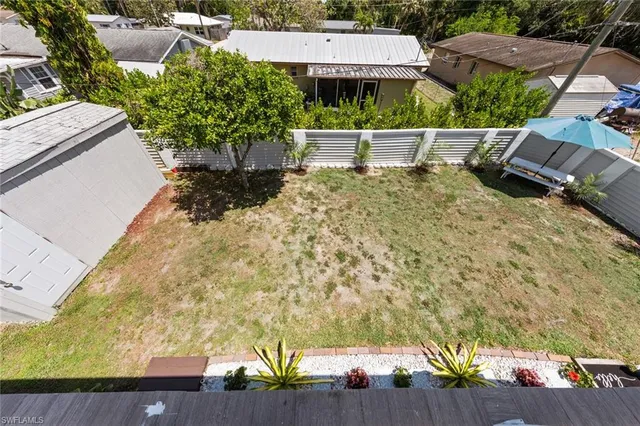 a view of a house with backyard and sitting area