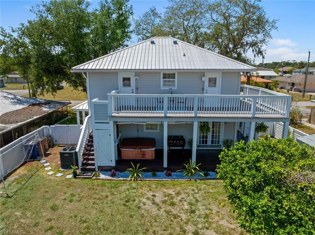 an aerial view of a house with a garden and lake view
