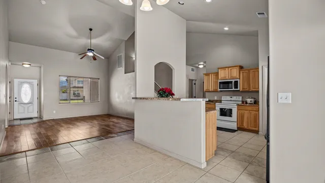 a kitchen with stainless steel appliances granite countertop a refrigerator and a stove top oven